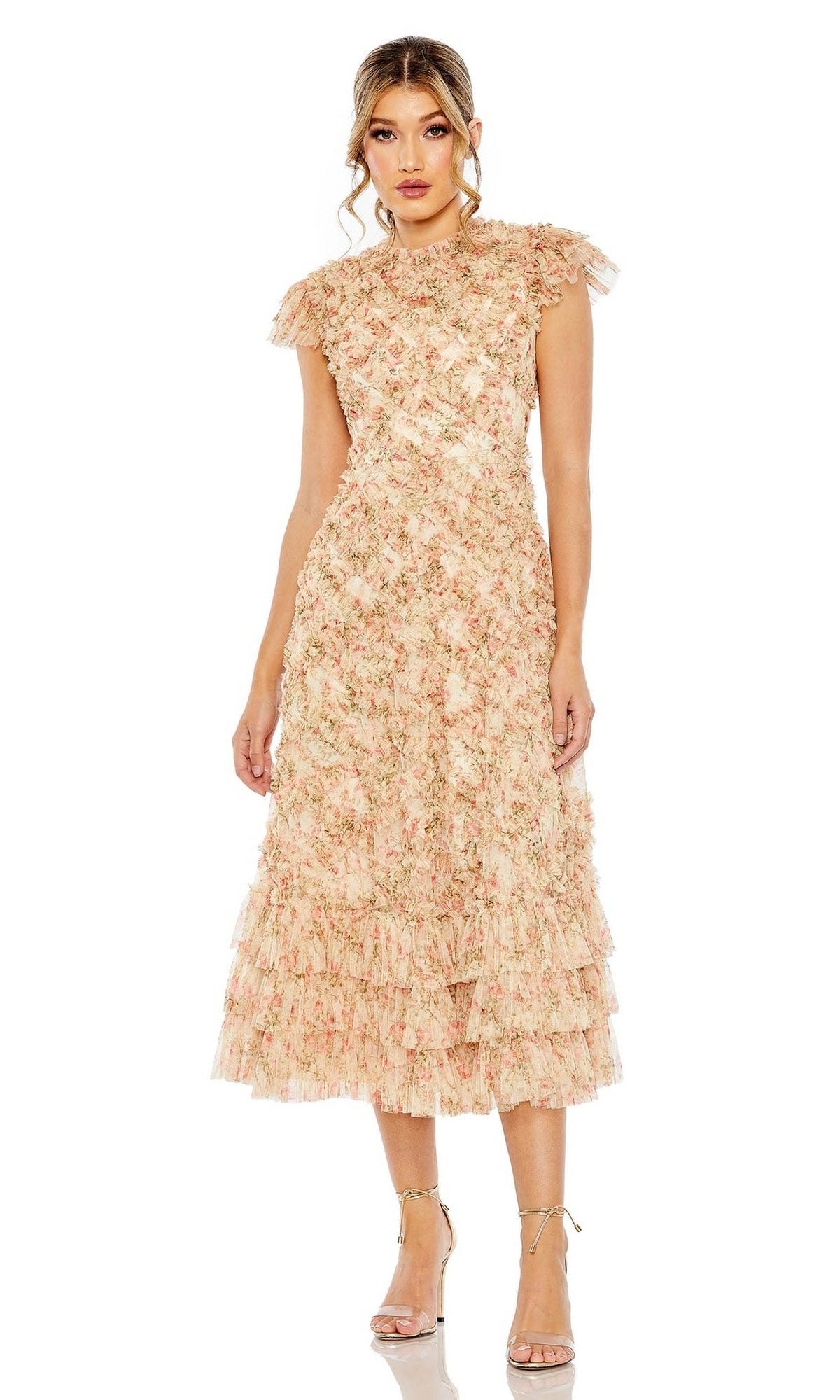 A woman wearing the Mac Duggal 8060 Cap-Sleeve Wedding Guest Dress in light peach with floral print, cap sleeves, and a tiered ruffled midi skirt, paired with nude high-heeled sandals.